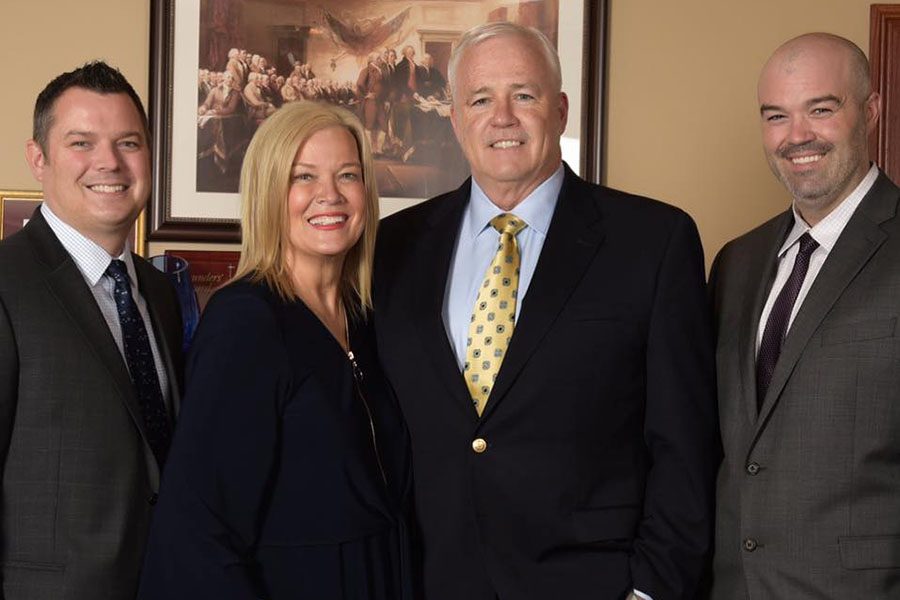 Homepage - Portrait of Smiling Aldridge Insurance Family Standing in the Aldridge Insurance Office
